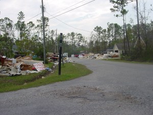 Katrina 7 – Another view down one of our streets. Everyone who was flooded had to put their ruined furniture, belongings, sheetrock and insulation somewhere. It makes driving around the neighborhood quite a challenge, because the debris starts spilling over into the streets.